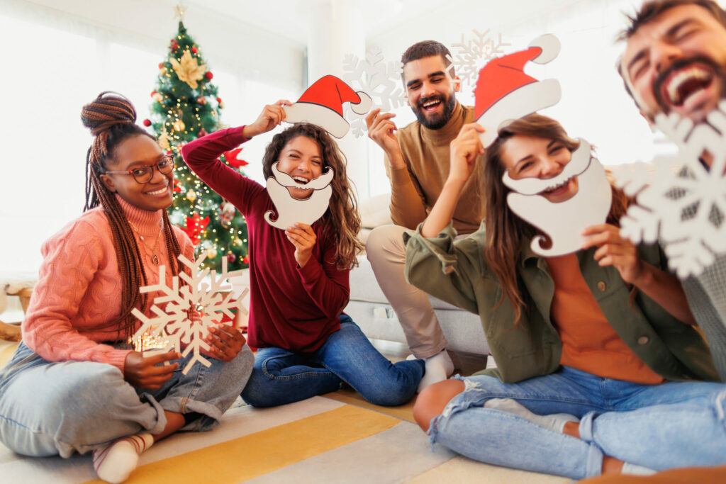 People laughing with Christmas masks