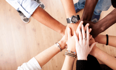Group of people stacking their hands together in a circle